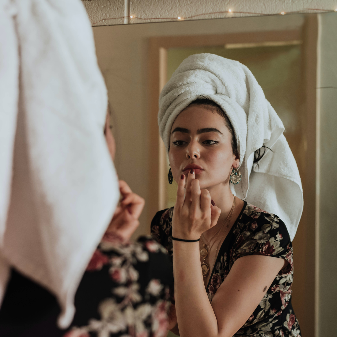 A woman looking at herself in the mirror